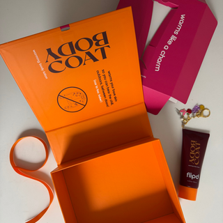 orange reusable box with bodycoat and ribbon